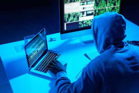 Hes in the hacking zone. a young male hacker cracking a computer code in the dark.