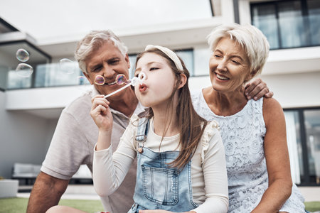 Smile, family and girl with bubbles and grandparents enjoying weekend, holiday and quality time...