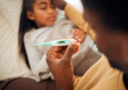 Child, girl and dad checking thermometer for ill kid or daughter lying on a bed feeling sad....