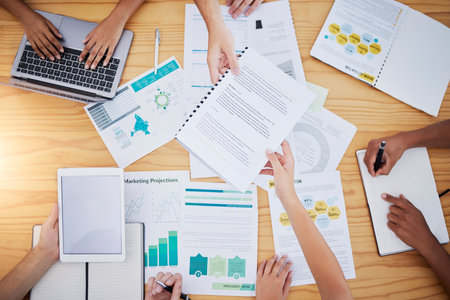 Hands, startup meeting or business people in data review for project management, SEO documents consult or collaboration. Digital agency, paper or agenda for planning, creative innovation or teamworkの写真素材