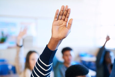 He knows all the answers. an unrecognizable varsity student raising his hand in class.の写真素材