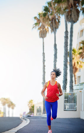 You get out of it what you put in. a sporty young woman out running in the city by herself.