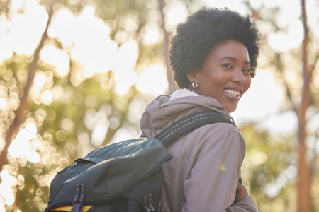 Black woman, portrait and hiking for fitness outdoors in nature for morning workout, training and...