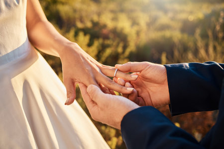 Hands, wedding couple and ring at ceremony outdoor with jewelry and save the date announcement....