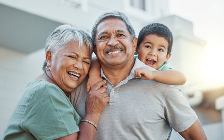 Grandparents, hug and child with smile for happy holiday or weekend break with elderly people at the...