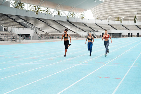 We keep each other on our toes. Full length shot of a young attractive group of athletes racing each...