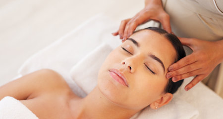 Spa, head massage and calm woman enjoying a relaxing treatment in a wellness, health and beauty center. Relax, peace and therapist doing relaxation therapy for a girl at a luxury natural salon.の写真素材