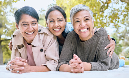 Portrait, family and sisters in a park with group of people, happy and laughing looking relax....