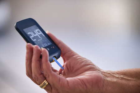 Hands, diabetes and glucometer, tool or measuring for blood sugar level, units or healthcare. Hand holding medical diagnostic device meter to measure insulin control or glucose for diabetic patientの写真素材