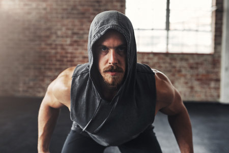 Beast mode on. muscular young man exercising at the gym.