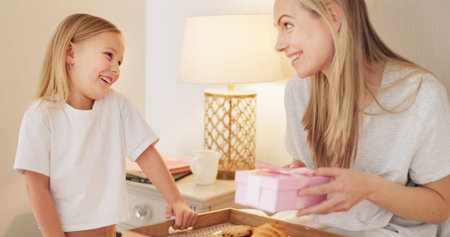 Breakfast, child and mama with a gift on mothers day in the morning to celebrate her mommy at home....