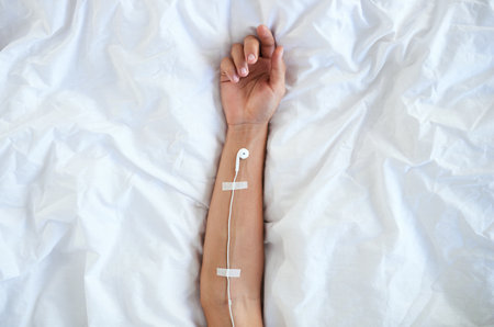 Music runs through my veins. High angle shot of earphones taped to an unrecognizable persons arm.の写真素材