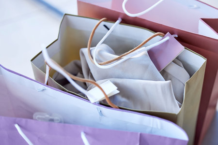 Shopping, bags and retail sale of luxury fashion or clothes of a shopaholic in a store, mall or...