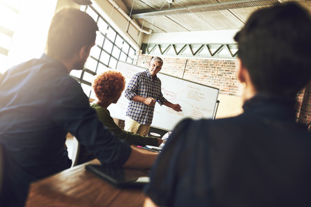 More ideas create more opportunities. a group of colleagues having an office meeting inside.の写真素材