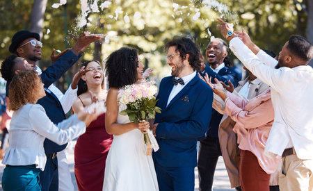 Confetti, wedding couple and marriage celebration of crowd throwing flower petals outdoor....