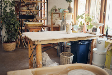 Creative, art and pottery with empty room of workshop for design, manufacturing and small business. Ceramics, interior and production with table in studio of for painting, inspiration and retailの写真素材