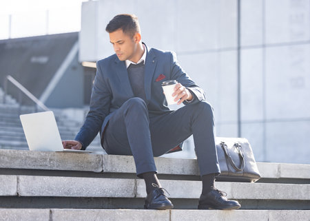 Thinking, city or business man with laptop for website search, communication or networking. Remote work, data analysis or employee in London street on tech for social network, research or blog reviewの写真素材