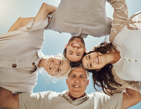 Happy family, portrait huddle and relax outdoor for travel holiday, summer vacation or comic support. Love, calm peace and happiness face together with blue sky background for sunshine adventureの写真素材