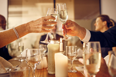 Success, hands or toast in a party in celebration of goals, achievement or new year at luxury event. Motivation, congratulations or people cheers with champagne drinks or wine glasses at dinner galaの写真素材