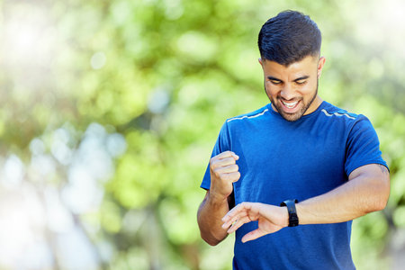 Exercise, mockup and watch with a man cheering his progress as a runner on a cardio or endurance workout. Fitness, running and health with a male athlete celebrating a target or goal while trainingの写真素材