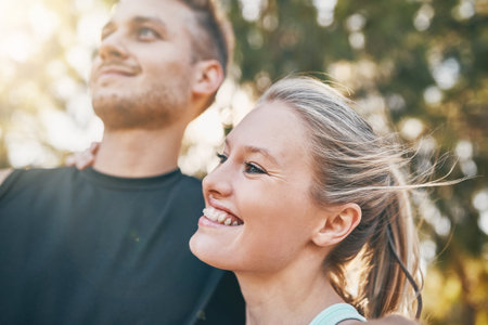 Sweat, smile and repeat. a young couple smiling together outdoors.の写真素材