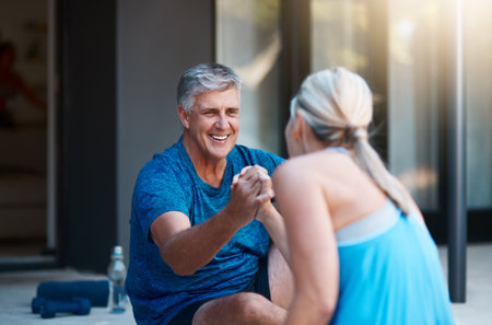 Were always rooting and supporting each other. a mature and motivated couple congratulating each other at the end of an intense workout session.の写真素材