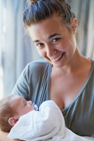 Isnt he just perfect. a young woman bonding with her baby boy at home.