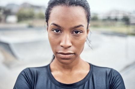 Fitness, woman and serious portrait for exercise, cardio workout or training in the city outdoors. African American female face looking in confidence or determination for sports, goals or exercisingの写真素材