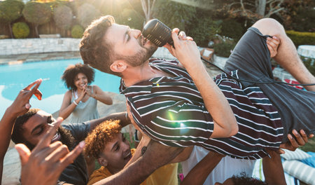 Microphone, singing and crowd surfing with a man performer at a party outdoor during summer....