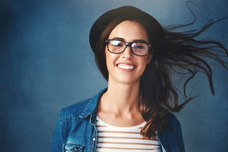 Life is simple when youre smiling. Studio portrait of an attractive young woman smiling against a...