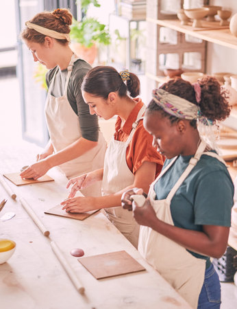 Pottery art and creative people row in workshop sculpting together for production process and...