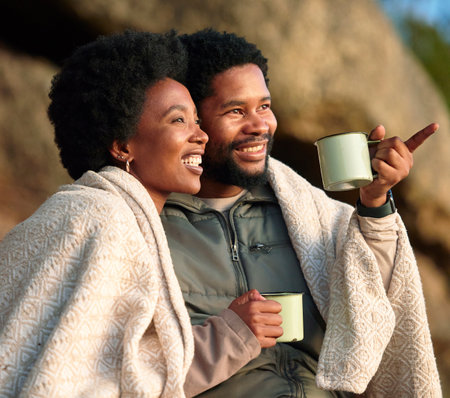 Relax, pointing and camping with black couple and coffee for wake up, hiking and sunrise. Nature, calm and adventure with man and woman and blanket in nature for trekking, mountaineering or discoveryの写真素材