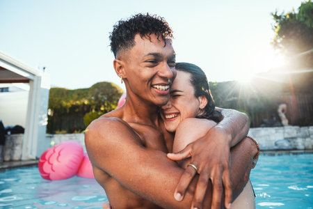Love, pool party and couple hug, having fun and bonding together. Swimming, romance diversity and happy man and woman hugging, cuddle or laugh at funny joke in water at summer event or celebration.の写真素材