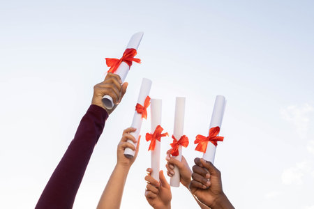Students graduation, hands and certificate in sky for success, education and future. Closeup group,...