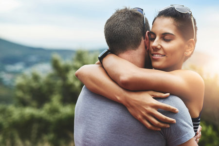 Tender moments filled with love. a young couple in a loving embrace outdoors.の写真素材