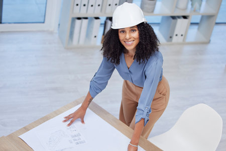 Architect, woman portrait and blueprint of engineer drawing plan on paper for building development. Happy contractor at office desk for project management, architecture and engineering mockup spaceの写真素材