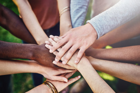 United on the friendship front. a group of friends joining their hands in solidarity.