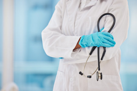 Cardiology, stethoscope and proud doctor hands for healthcare, heart wellness and insurance in hospital. Medical blurred background, professional and cardiologist with career equipment in clinic zoomの写真素材