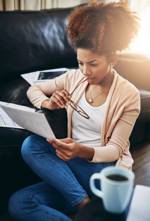 Her future self will thank her for responsible financial planning. a young woman going through her...