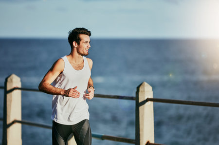 Running is my escape. a sporty young man out for a run.