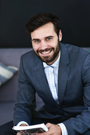 I aim to get the job done no matter what. Portrait of a young businessman reading a book in a modern...