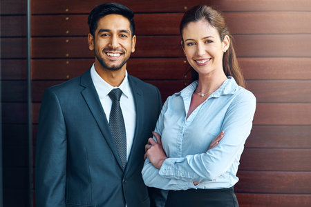 Together we achieve more. two businesspeople standing outside the office.