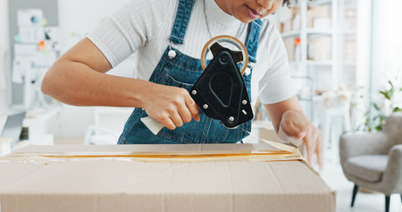 Woman packing box, package and cargo with tape for delivery, sale and shipping in workshop, startup...