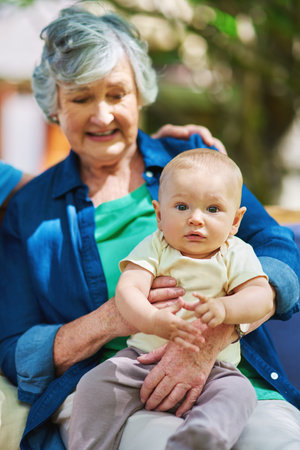 The love between a grandmother and grandson is forever. a baby boy with his family outdoors.