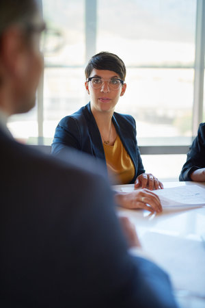 Exchanging information. three corporate businesspeople working in the boardroom.