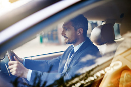 The morning commute. a handsome businessman on his morning commute to work.の写真素材