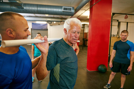 Do it for yourself. a senior man doing pvc pipe exercises with the assistance of his trainer.