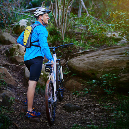 Life is better when youre biking. a male cyclist out for a ride on his mountain bike.