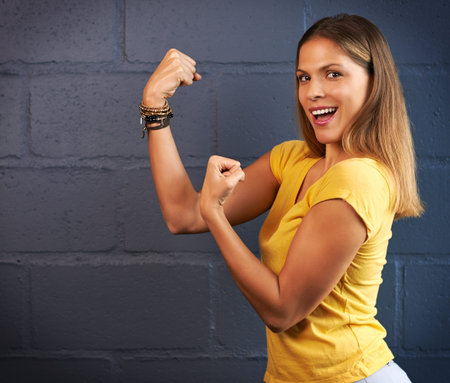 Are you sure you wanna take on these muscles. Cropped portrait of a young woman putting up her fists...