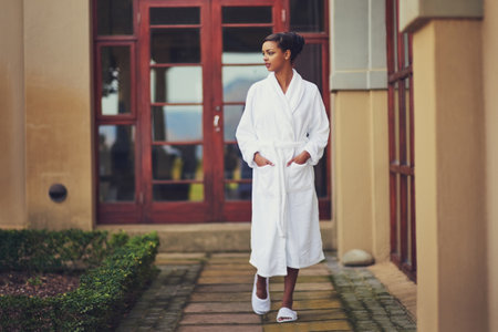 Nothing to do today but relax. an attractive young woman going for a walk outside at a spa.の写真素材